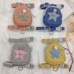 Four small harnesses from the Dog Traction Rope Adjustable Pet Knapsack series are displayed on a surface. Available in pink, blue, gray, and yellow, each harness features a star-shaped patch adorned with a pom-pom and embroidered with the word "love." The harnesses include gray straps and metal rings for leash attachment.