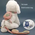 A plush white dog is adorned with a pink harness that includes a versatile bag showcasing a star design. The item is labeled as the "Dog Traction Rope Adjustable Pet Knapsack." Additionally, there is a close-up image highlighting a blue harness paired with a matching leash.